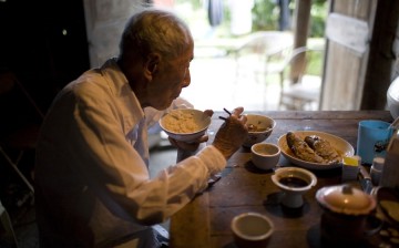 Zheng Xuechu, born in 1910, has dinner at his home in Taizhou city, East China's Zhejiang province, on June 21, 2011. 