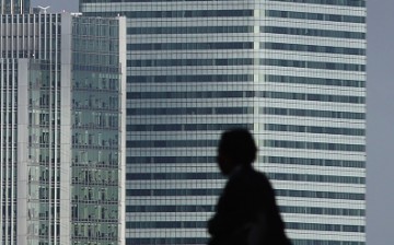 A man is silhouetted against the HSBC Holdings Plc headquarter in the Canary Wharf business, financial and shopping district on Feb. 15, 2016, in London, England.