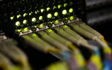 Fiber-optic cables are attached into a server inside a communications room in London.