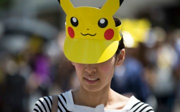 A woman wearing a Pikachu shaped sun visor arrives for the Pikachu Outbreak event hosted by The Pokemon Co. on August 7, 2016 in Yokohama, Japan. 