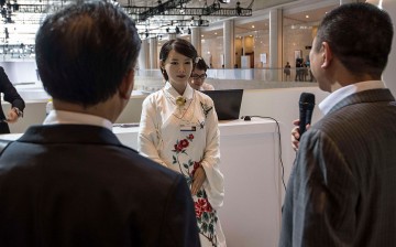 Visitors talk to Jiajia, a humanoid robot developed and created by scientists from the University of Science and Technology of China, during the World Economic Forum in June.