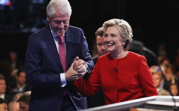 Democratic presidential nominee Hillary Clinton shakes hands with husband and former U.S. President Bill Clinton after the second 2016 Presidential Debate at Hofstra University in Hempstead, New York.