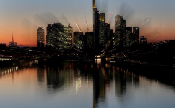 Skyscrapers, many of them belonging to leading European banks, stand illuminated in the city center on Oct. 31, 2012, in Frankfurt, Germany.