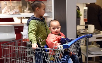 Don’t worry I've got your back: Two boys keep each other company at a furniture store in Beijing, on Jan. 19, 2015.