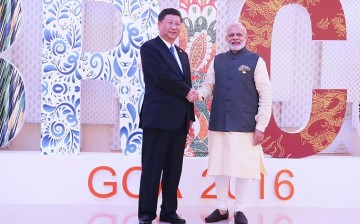 (L) Chinese President Xi Jinping and Indian Prime Minister Narendra Modi shake hands at the 8th BRICS Summit in Goa, India, on Oct. 16.
