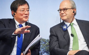 Ren Jianxin, chairman of ChemChina, talks to Michel Demare, chairman of Swiss farm chemicals giant Syngenta, during a press conference at the company's headquarters in Basel, Switzerland.