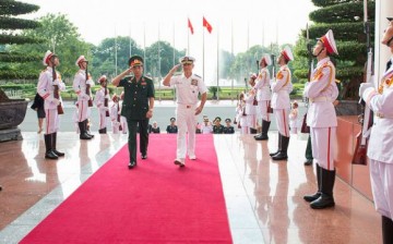 Lt. Gen. Phan Van Giang and Adm. Harry Harris Jr., commander of U.S. Pacific Command, during an honor ceremony at Vietnam's Ministry of National Defense.
