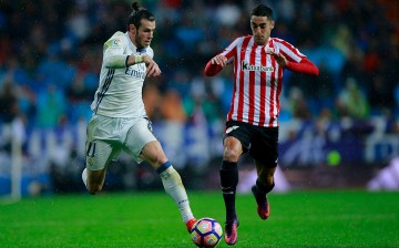 Athletic Bilbao forward Sabin Merino (R) competes for the ball against Real Madrid's Gareth Bale.