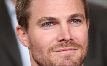 Actor Stephen Amell listens onstage to the panel discussion during the 'Arrow' and 'The Flash' panel as part of The CW 2015 Winter Television Critics Association press tour at the Langham Huntington Hotel & Spa on January 11, 2015 in Pasadena, California.