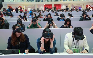 Members of the media wear virtual reality (VR) headsets to experiences VR shopping during Singles' Day.