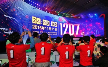Alibaba's staff take photos of the screen showing the company's sales figure during last Friday's Singles' Day event.