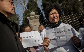 A Chinese relative of a missing passenger on Malaysia Airlines flight MH370 cries at a protest outside the Malaysia Embassy on March 8, 2015 in Beijing, China.