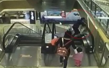 A grandmother desperately tries to save her 4-month-old grandson as he falls from a mall escalator.