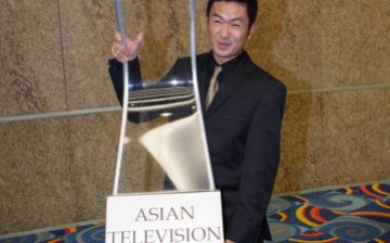 Singapore comedian and actor Adrian Pang lifts a model of the Asian Television Awards trophy after the 2006 gala event at the Suntec Singapore International Convention & Exhibition Centre ... 
