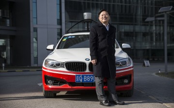 Wang Jing, Baidu's senior vice president, poses with one of the company's autonomous cars at Baidu's headquarters in Beijing.