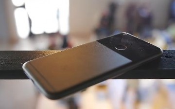 The Google Pixel XL, Google's first smartphone, is placed on a railing.