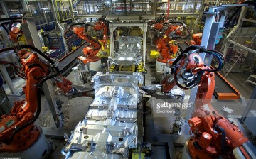 Robotic arms work at a car assembly manufacturing plant in Beijing.