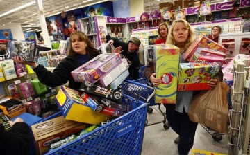 Shoppers Jeri Hull (L) and Karen Brashear (R) wait in line while shopping at Toys'R'Us during the Black Friday sales event on November 27, 2009 in Fort Worth, Texas. 