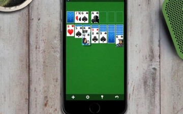 Microsoft Solitaire which was released for iOS and Android this week, being played on an iPhone.