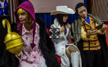 Characters from the One Piece Group take selfies on April 23, 2016 in Yangon, Burma.