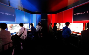 Visitors play the Titanfall 2 video game in the Konami Holdings Corp. booth at the Tokyo Game Show 2016 on September 15, 2016 in Chiba, Japan.