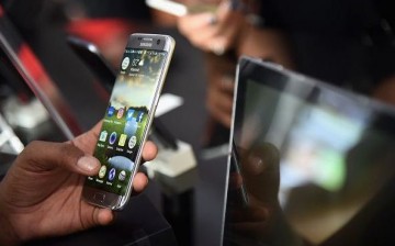 A consumer enjoys the Samsung Galaxy S7 Edge smart phone at The Samsung Experience at the PGA Championship 2016 at Baltusrol Golf Club on July 30, 2016 in Springfield, New Jersey.