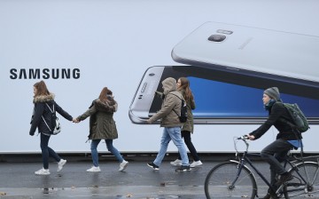 Pedestrians pass through the Samsung Galaxy S8 billboard.