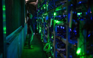 A Bitcoin site manager checks the equipment in a Bitcoin mine in Sichuan.