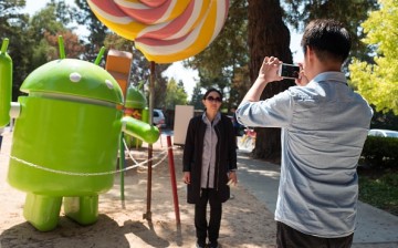 Tourists take photos in front of Google at the Silicon Valley town of Mountain View, California.