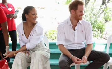 Prince Harry (R) watches as Singer Rihanna (L) gets her blood sample taken for an live HIV test, in order to promote more widespread testing for the public at the 'Man Aware' event held by the Barbados National HIV/AIDS Commission on the eleventh day of a