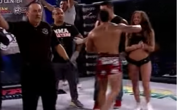 Titan FC's Andrew Whitney unintentionally punches ring girl after learning of title loss.