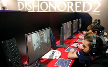 Gamers play the video game 'Dishonored 2' developed by Arkane Studios and published by Bethesda Softworks during the 'Paris Games Week' on October 28, 2016 in Paris, France.