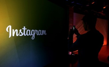 An attendee takes a photo of the instagram logo during a press event at Facebook headquarters on June 20, 2013 in Menlo Park, California. Facebook announced that its photo-sharing subsidiary Instagram will now allow users to take and share video. 
