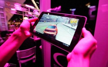 An exhibitor plays a video on the T-Mobile LG G-Slate tablet at the T-Mobile booth during the Electronic Entertainment Expo on June 7, 2011 in Los Angeles, California.