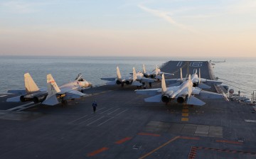 This picture taken on an undisclosed date in December 2016 shows Chinese J-15 fighter jets waiting on the deck of the Liaoning aircraft carrier during military drills in the Bohai Sea, off China's northeast coast.