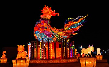 2017 marks the Year of the Rooster. The picture shows a huge rooster standing in the center, surrounded by the other 11 animals of the Chinese zodiac. 