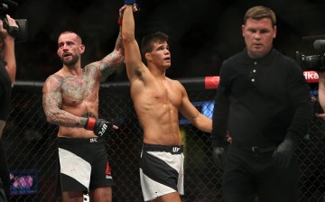 CM Punk raises Mickey Gall's hand after he was beaten in their UFC 203 encounter.