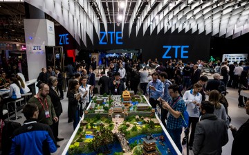 Attendees visit the stand of ZTE during the second day of the Mobile World Congress 2016.