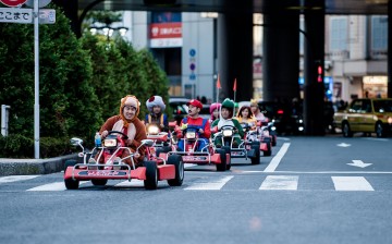 Participants drive around Tokyo in 'Mario Kart' characters for the Real Mario Kart event in Tokyo on November 16, 2014 in Tokyo, Japan.