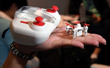 The H001 Nano Q4 SE remote control quadcopter by Hubsan is displayed next to its controller that doubles as the unit's carrying case at InterDrone.