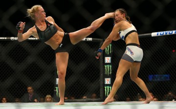 Holly Holm lands a hard head kick against Miesha Tate in their match at UFC 196 held last March 5, 2016.