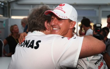 Michael Schumacher embraces Mercedes Motorsport President Norbert Haug after announcing his retirement.