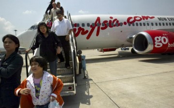 Travellers are seen disembarking from the Air Asia Boeing 737-300 flight from Bangkok to Phuket on February 25, 2004 in Phuket, Thailand. 