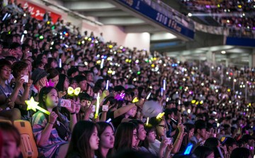 South Korean K-Pop fans, mostly of a boy band called Exo, cheer as a K-Pop band perform on stage on June 18, 2016 in South Korea. The government try to boost tourism by sponsoring and directly organizing K-Pop concerts in big venues.   