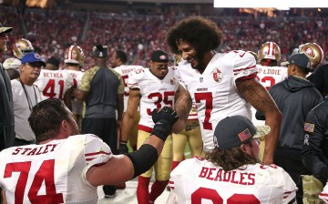 Colin Kaepernick of the San Francisco 49ers and tackle Joe Staley high five on the bench after a Kapernick's fourth quarter touchdown during NFL football game against the Arizona Cardinals at University of Phoenix Stadium on November 13, 2016 in Glendale,