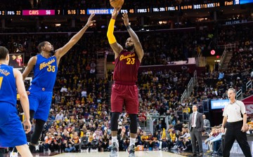 LeBron James of the Cleveland Cavaliers shoots over Kevin Durant of the Golden State Warriors during the second half at Quicken Loans Arena on December 25, 2016 in Cleveland, Ohio.