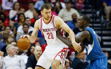 Donatas Motiejunas of the Houston Rockets drives with the basketball against Gorgui Dieng of the Minnesota Timberwolves during their game at the Toyota Center on March 18, 2016 in Houston, Texas. 