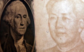 Details of dollar and a yuan notes are seen at a bank on May 15, 2006 in Beijing, China.
