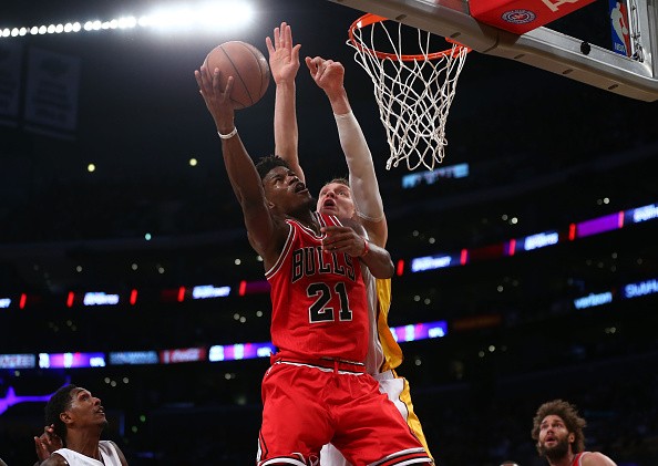 LOS ANGELES, CA - NOVEMBER 20: Jimmy Butler #21 of the Chicago Bulls goes up for the layup against Timofey Mozgov #20 of the Los Angeles Lakers during the first half of the NBA game at Staples Center on November 20, 2016 in Los Angeles, California.