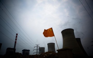 A Chinese flag flies over a coal-fired power plant in China.
